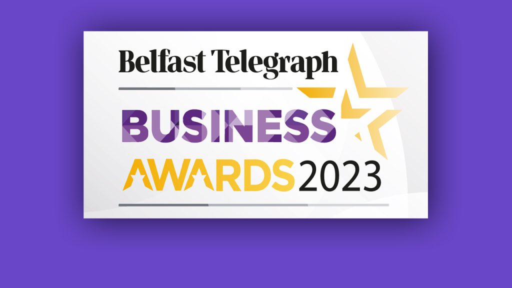 Belfast Telegraph Business Awards 2023 logo with purple and yellow text, a stylized yellow star, on a white background with a purple border.