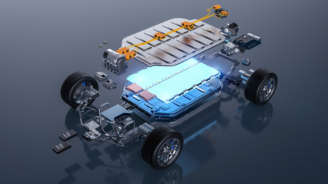 An exploded-view illustration of an electric vehicle chassis shows components like the battery pack, wiring, wheels, and frame individually separated and highlighted on a reflective surface.