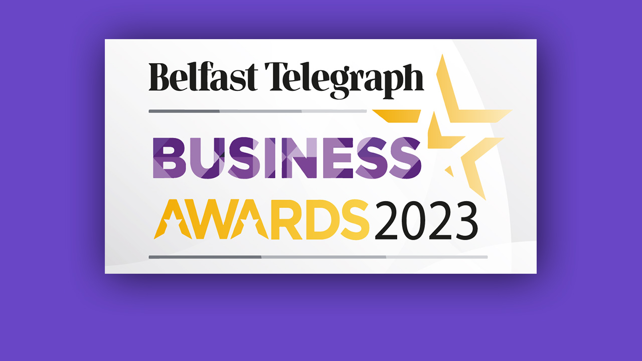 Belfast Telegraph Business Awards 2023 logo with purple and yellow text and a yellow star on a white background, set against a purple backdrop.