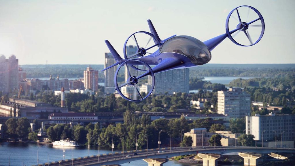 A futuristic blue flying car with four propellers hovers above an urban landscape with tall buildings, greenery, a river, and bridges. The sky is clear, suggesting a sunny day.