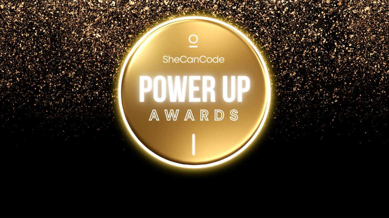 Gold circle with "SheCanCode POWER UP AWARDS" written in the center, surrounded by sparkling gold glitter on a black background.